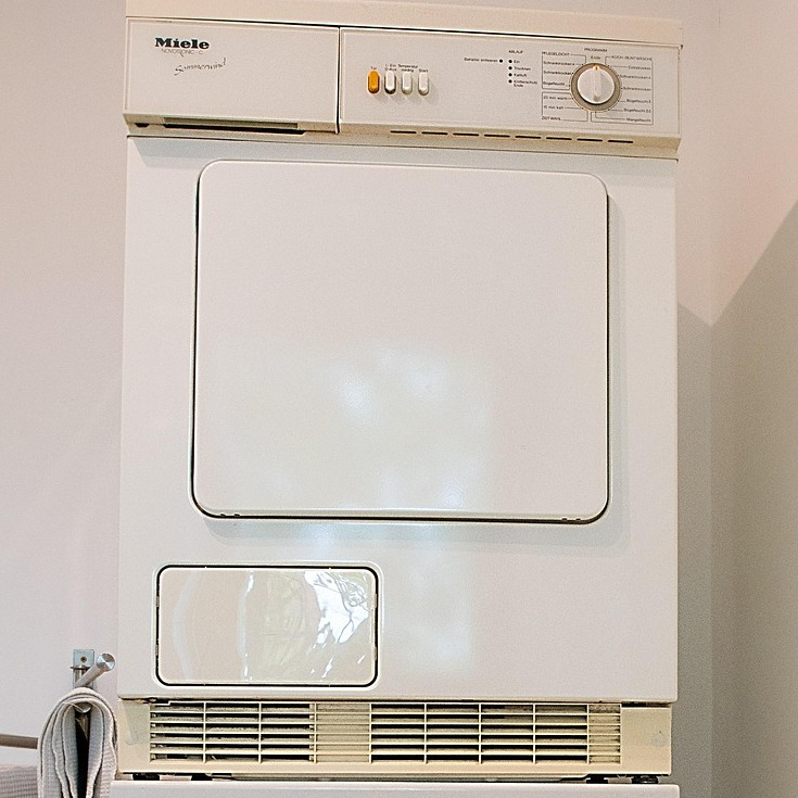Image featuring a dryer and how important it is to have the dryer vent cleaned.